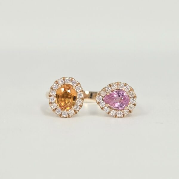 Bague ouverte en or rose avec deux saphirs de couleurs différentes sertis de diamants.